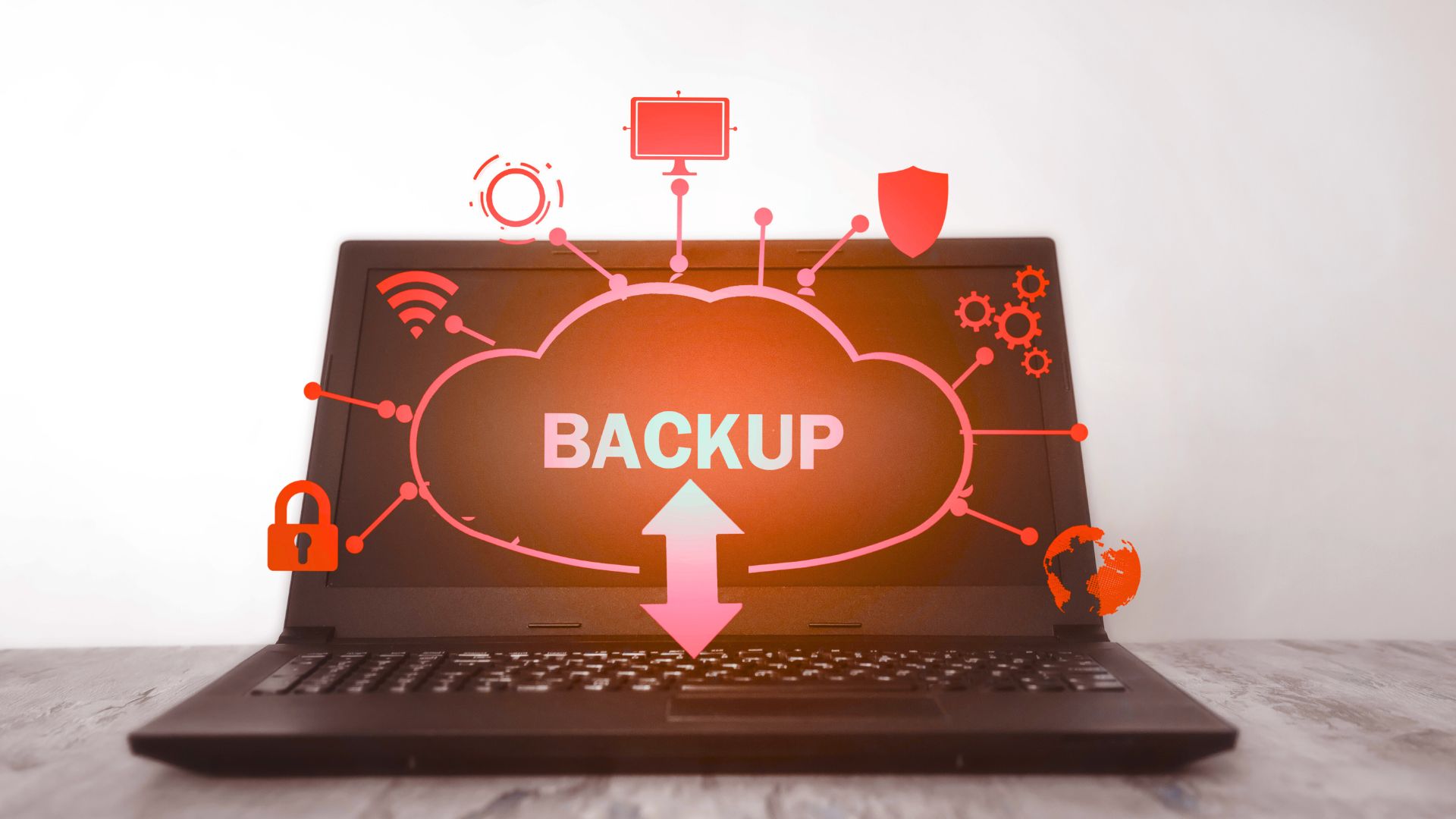 Laptop with digital cloud backup graphic showing data protection and connectivity icons, symbolising disaster recovery and secure storage.