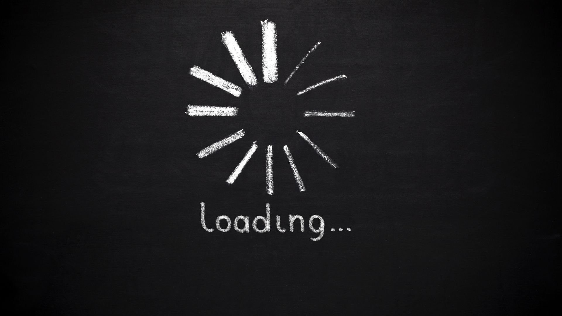 Chalk-drawn loading icon and the word “loading…” on a blackboard background.