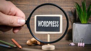 Magnifying glass focusing on a mini chalkboard sign that reads “WordPress