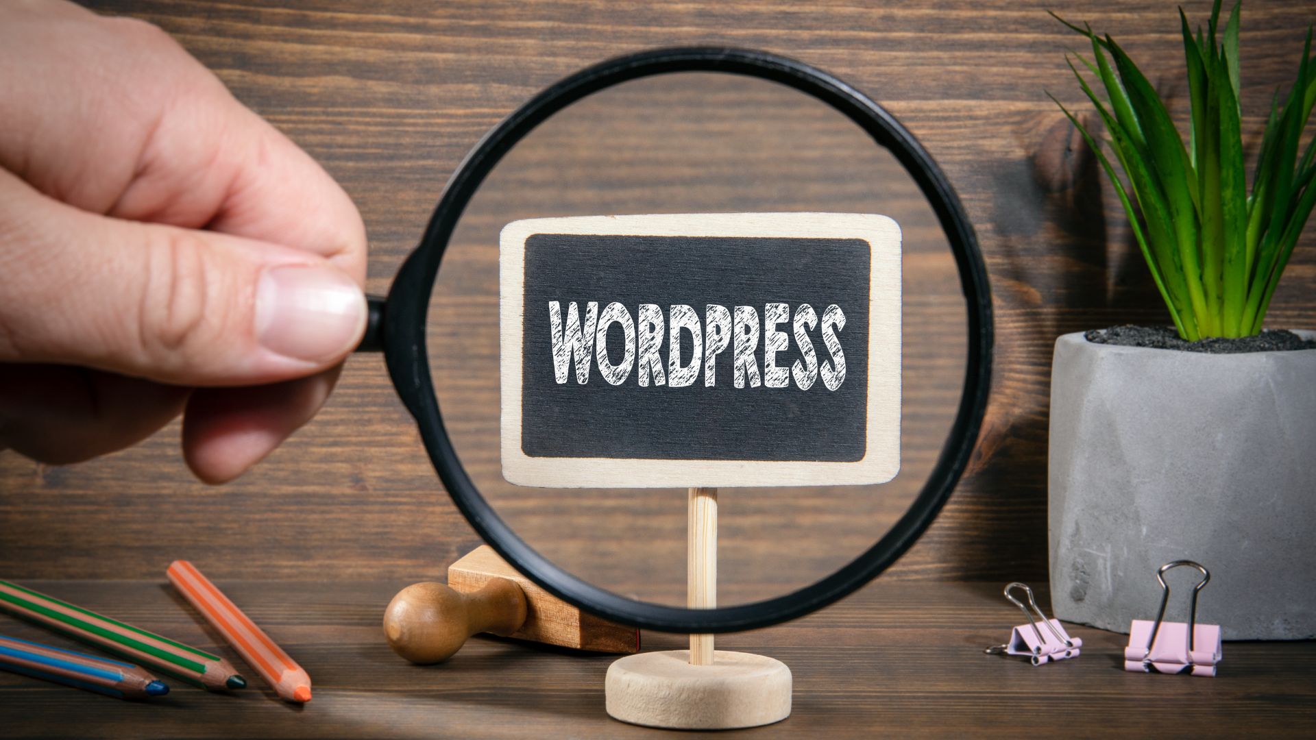 Magnifying glass focusing on a mini chalkboard sign that reads “WordPress
