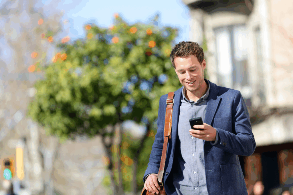 man smiling at phone