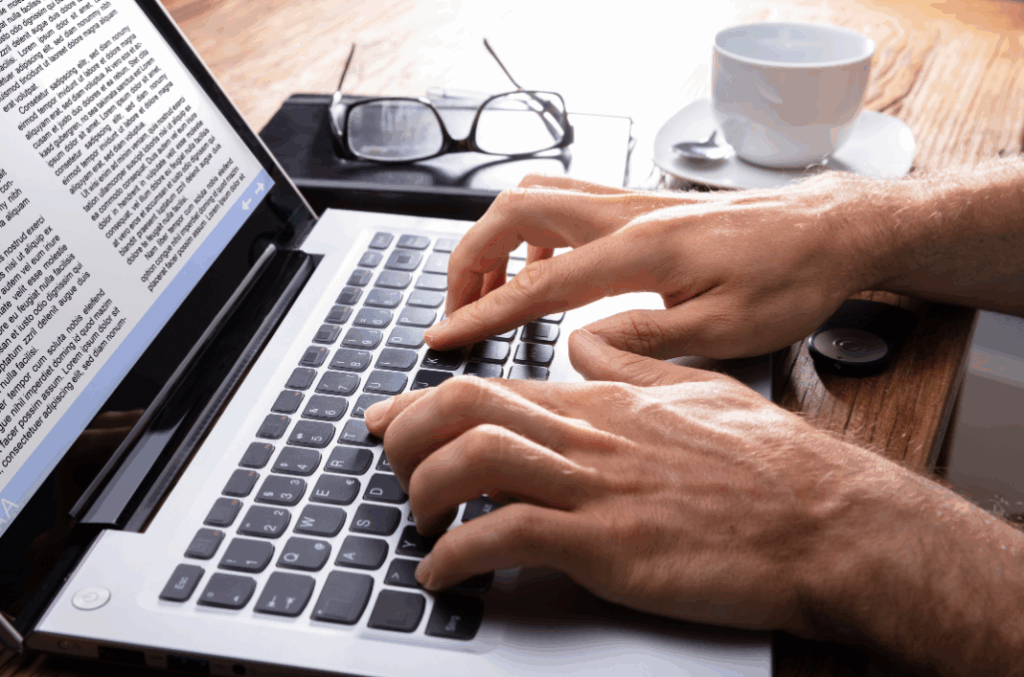 man typing on laptop
